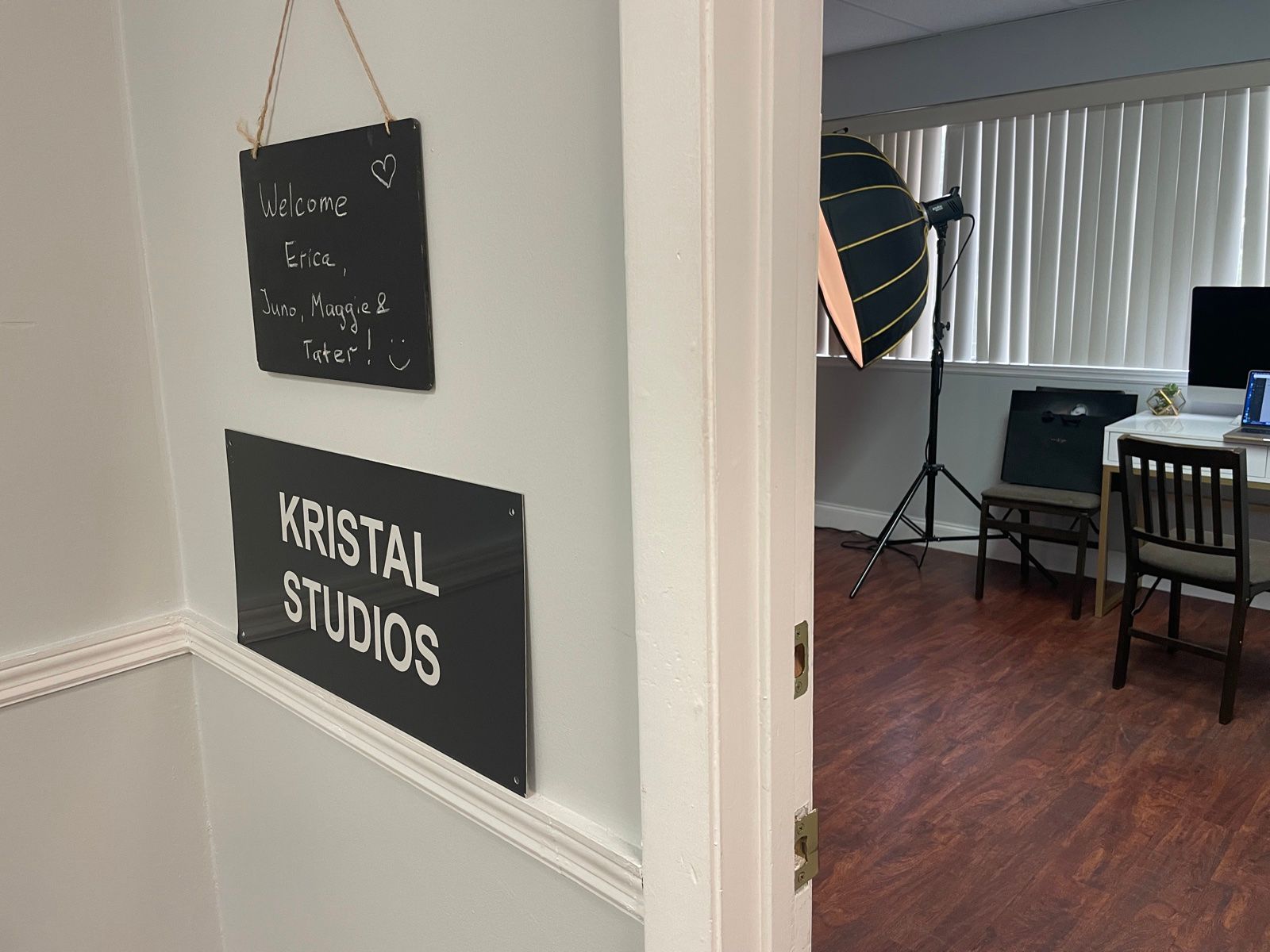 The studio door with its Kristal Studios sign and a chalkboard welcoming the day's clients