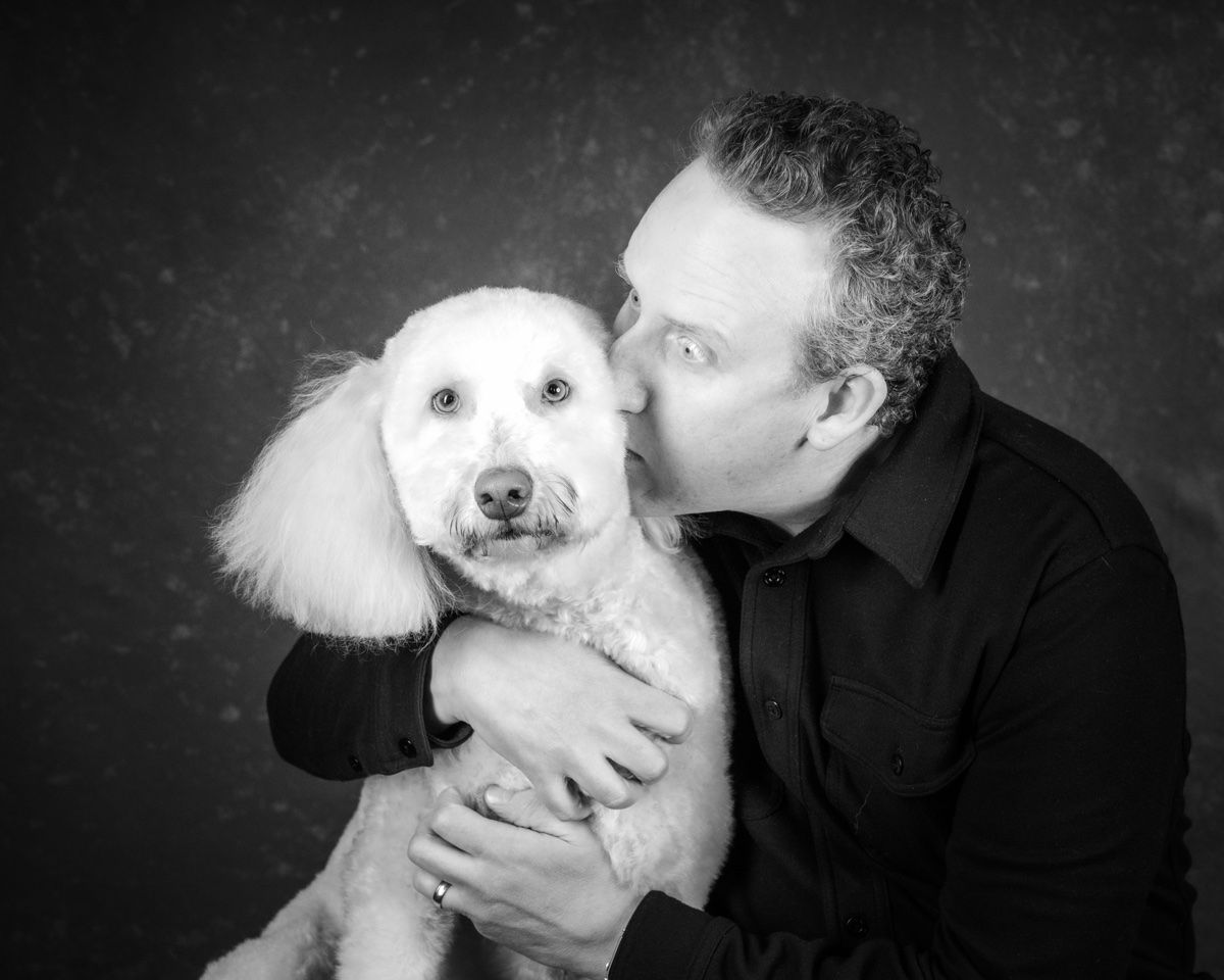 The husband kissing the poodle