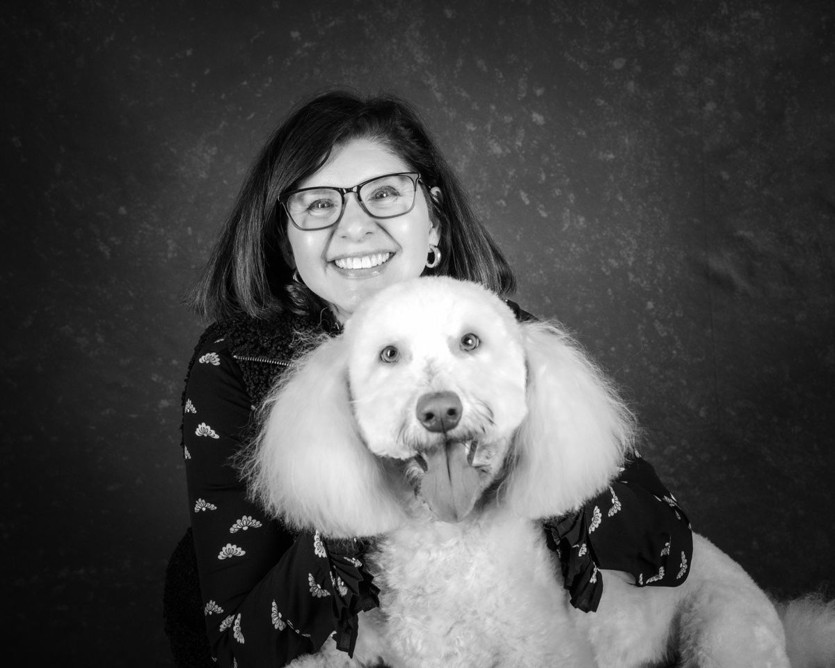 The wife cheek to cheek with the poodle