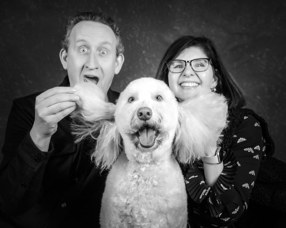 The husband pulling a face beside the poodle